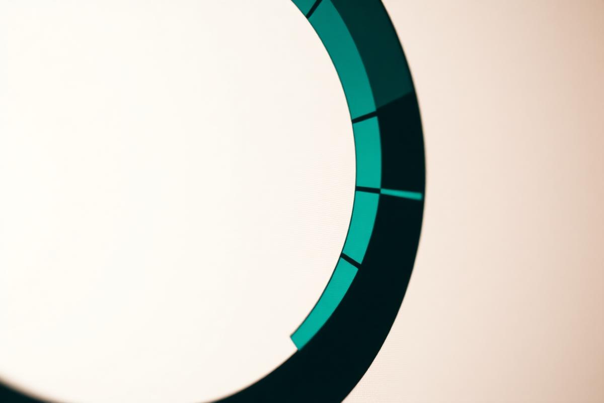 Close-up of a teal circular progress ring on a screen, partially filled